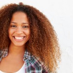 Portrait Of Woman Standing Outdoors Against White Wall